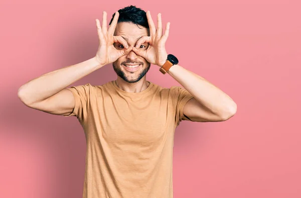 Hispanic Man Beard Wearing Casual Shirt Doing Gesture Binoculars Sticking —  Fotos de Stock