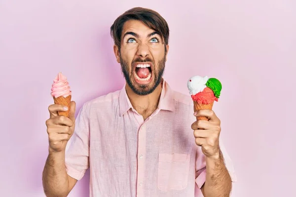 Young Hispanic Man Holding Ice Cream Angry Mad Screaming Frustrated — Stock Photo, Image