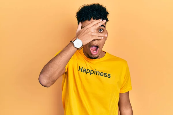 Joven Hombre Afroamericano Vistiendo Camiseta Con Mensaje Palabra Felicidad Asomándose — Foto de Stock