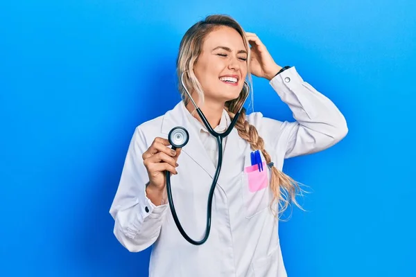 Beautiful Young Blonde Doctor Woman Holding Stethoscope Smiling Confident Touching — Stock Photo, Image