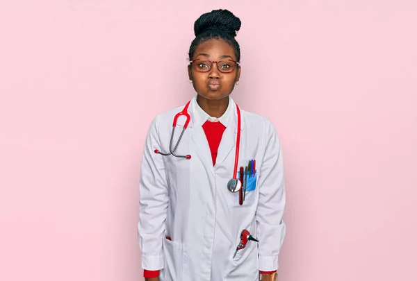 Young African American Woman Wearing Doctor Uniform Stethoscope Puffing Cheeks — Stock Photo, Image