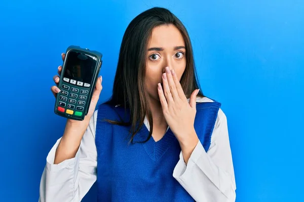 Young Hispanic Girl Holding Dataphone Covering Mouth Hand Shocked Afraid — Stock Photo, Image