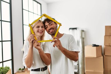 Genç ve güzel bir çift gülümsüyor. Mutlu ev projeleri..