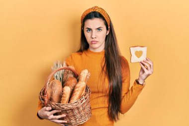 Genç esmer ergen hasır sepeti elinde ekmek ve bir somun ekmekle yüzünde ciddi bir ifadeyle rahatlamıştı. Basit ve doğal bir şekilde kameraya bakıyorsun.. 