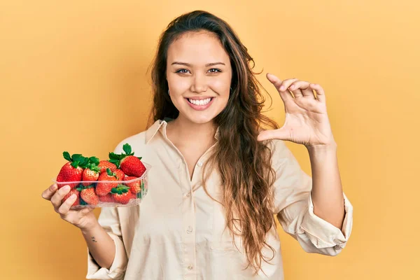 Joven Chica Hispana Sosteniendo Fresas Sonriente Seguro Gesto Con Mano —  Fotos de Stock