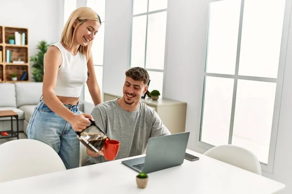 Man Working Using Laptop Home His Girlfriend Pouring Coffee — Stock Photo, Image