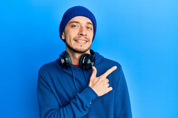 Hispanic Young Man Wearing Sweatshirt Headphones Cheerful Smile Face Pointing — Stock Photo, Image