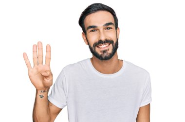 Gündelik beyaz tişört giyen genç İspanyol adam dört numarayı gösterip işaret ederken kendinden emin ve mutlu bir şekilde gülümsüyor.. 