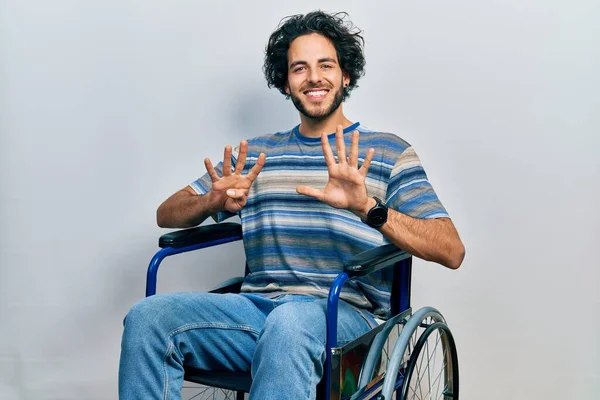 Handsome Hispanic Man Sitting Wheelchair Showing Pointing Fingers Number Nine — Stock Photo, Image