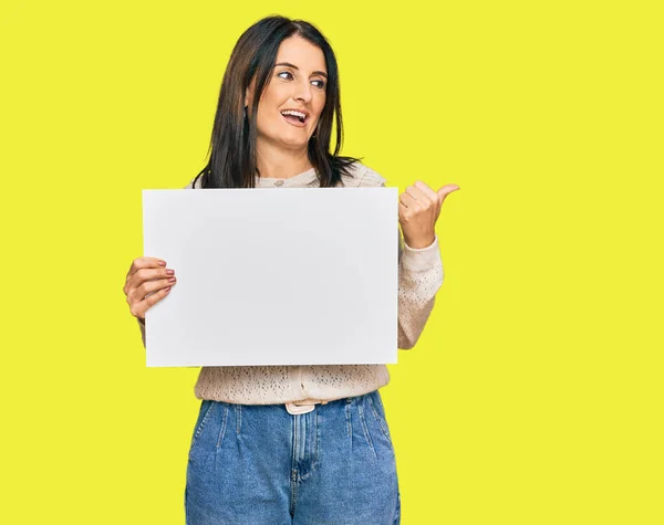 Middle Age Brunette Woman Holding Blank Empty Banner Pointing Thumb — Stock Photo, Image