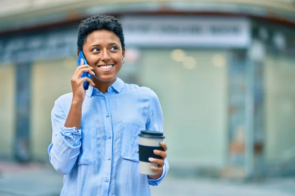 若いアフリカ系アメリカ人の女の子がスマートフォンで話して街でコーヒーを飲んで — ストック写真