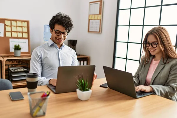 Two business workers smiling happy working at the office.