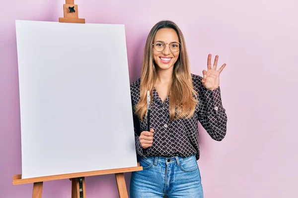 Hermosa Mujer Hispana Parada Junto Caballete Pintor Sosteniendo Pinceles Haciendo — Foto de Stock