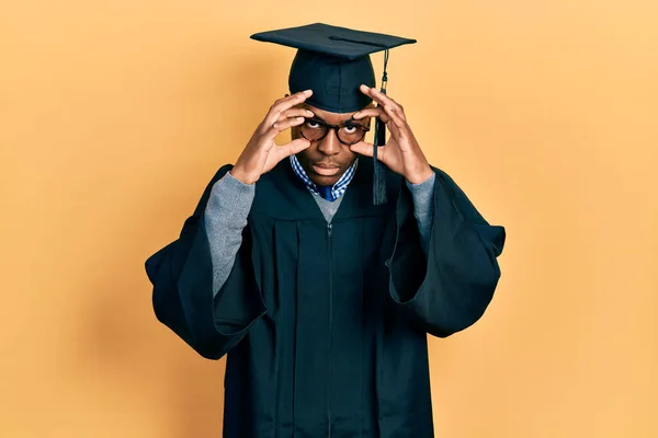 Young African American Man Wearing Graduation Cap Ceremony Robe Trying — Stock Photo, Image