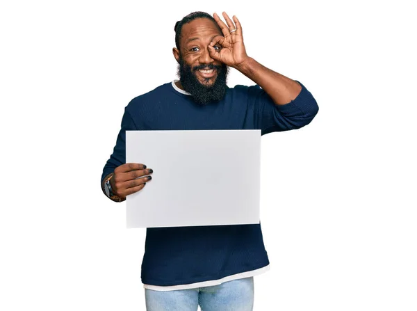 Young African American Man Holding Blank Empty Banner Smiling Happy — Stock Photo, Image