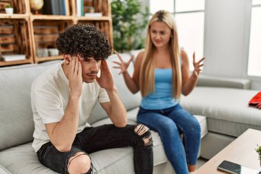 Genç bir çift kanepede oturup tartışıyor..