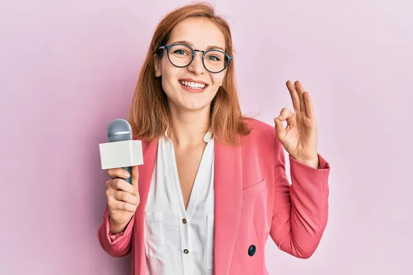 Young Caucasian Woman Holding Reporter Microphone Doing Sign Fingers Smiling — Stock Photo, Image
