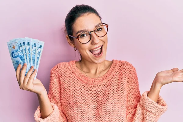 Young Caucasian Woman Holding Thai Baht Banknotes Celebrating Achievement Happy — Stock Photo, Image