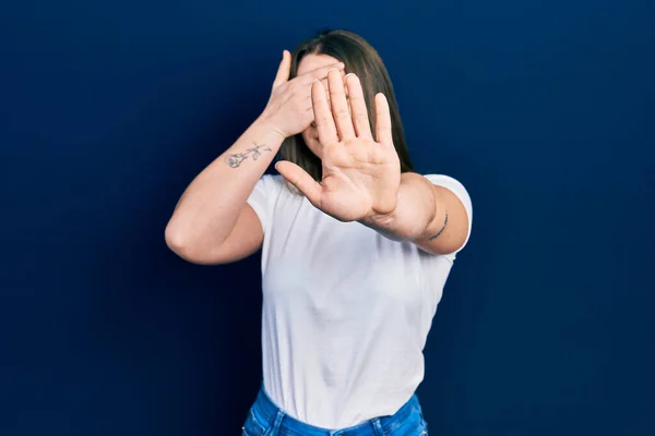 Young Hispanic Girl Wearing Casual White Shirt Covering Eyes Hands — Stock Photo, Image