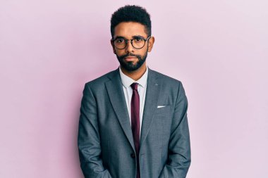 Handsome hispanic business man with beard wearing business suit and tie skeptic and nervous, frowning upset because of problem. negative person.  clipart