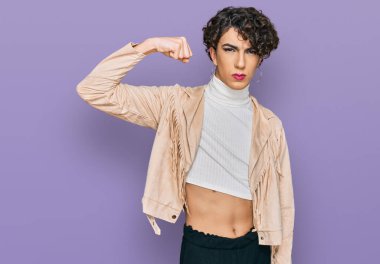 Makyaj yapan yakışıklı bir adam ve kadın kıyafetleri giyen güçlü kol kası gösteren, kendinden emin ve gururlu bir adam. 