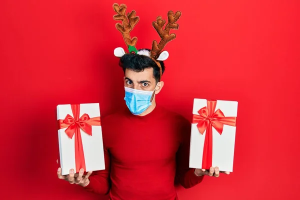 Young Hispanic Man Wearing Cute Christmas Reindeer Horns Medical Mask — Stock Photo, Image
