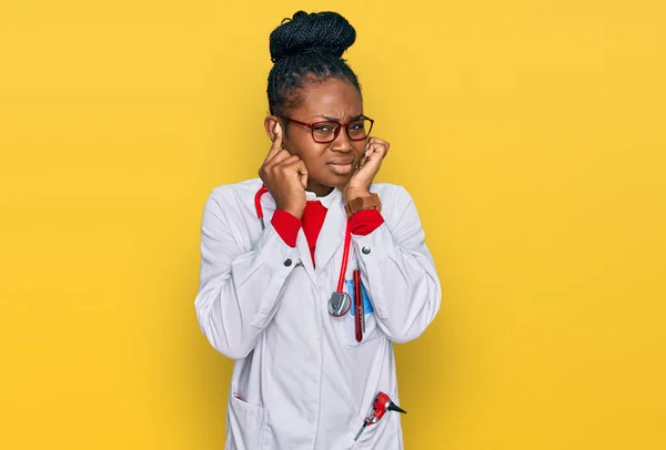 Young African American Woman Wearing Doctor Uniform Stethoscope Covering Ears — Stock Photo, Image