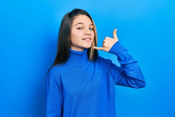 Young Brunette Girl Wearing Turtleneck Sweater Smiling Doing Phone Gesture — Stock Photo, Image