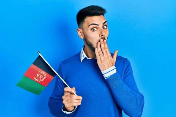 Young Hispanic Man Beard Holding Afghanistan Flag Covering Mouth Hand —  Fotos de Stock