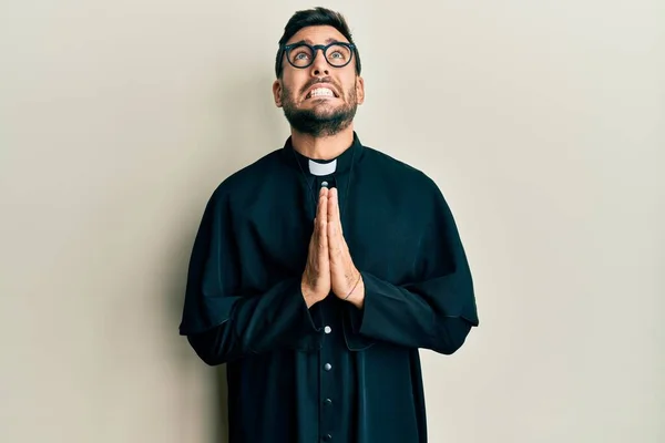 Young Hispanic Man Wearing Priest Uniform Standing White Background Begging —  Fotos de Stock