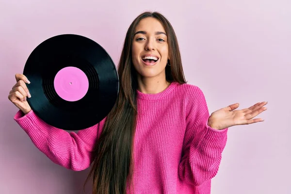 Young Hispanic Girl Holding Vinyl Disc Celebrating Achievement Happy Smile — Stockfoto