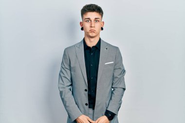 Kulakları genişlemiş, iş ceketi giymiş, depresyonda ve üzüntüden ağlayan sinirli ve korkmuş beyaz bir çocuk. hüzünlü ifade. 