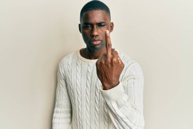 Young african american man wearing casual clothes showing middle finger, impolite and rude fuck off expression 