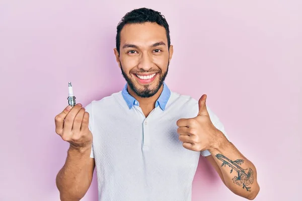 Hispanic Man Beard Holding Spark Plug Smiling Happy Positive Thumb — Foto de Stock