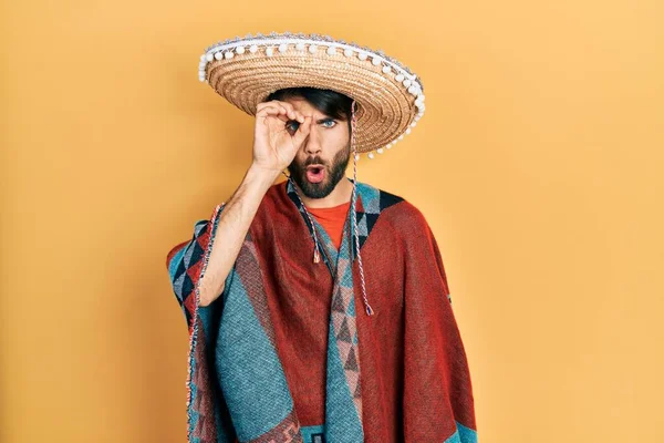 Young Hispanic Man Holding Mexican Hat Doing Gesture Shocked Surprised — Stock Fotó