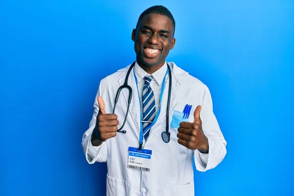 Young African American Man Wearing Doctor Uniform Success Sign Doing — Stock Photo, Image