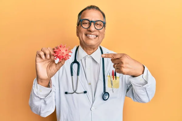 Middle Age Indian Man Wearing Doctor Coat Holding Virus Toy — ストック写真