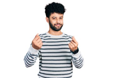 Sakallı, sıradan çizgili süveter giyen, elleriyle para hareketi yapan, maaşını ödemesini isteyen genç bir Arap. Milyoner işi. 