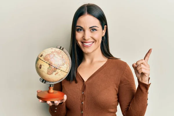 Young Brunette Woman Holding Vintage World Ball Smiling Happy Pointing — ストック写真