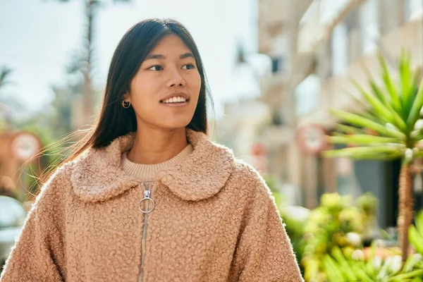 年轻的亚洲女人笑着站在城市里 — 图库照片