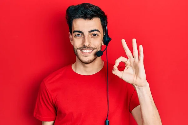 Young Hispanic Man Wearing Call Center Agent Headset Doing Sign — Stock Photo, Image