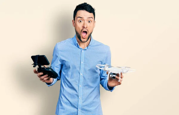 Hispanic Man Beard Using Drone Remote Control Afraid Shocked Surprise — Stock Photo, Image