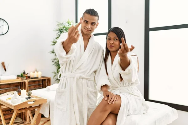 Young Latin Couple Wearing Towel Standing Beauty Center Showing Middle — Stockfoto