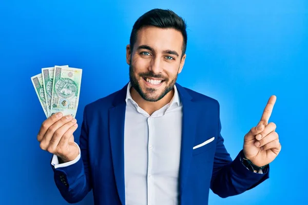 Young Hispanic Businessman Wearing Business Suit Holding Polish Zloty Banknotes — Zdjęcie stockowe