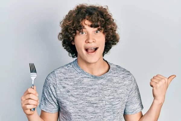 Handsome Young Man Holding One Silver Fork Pointing Thumb Side — Stock Photo, Image