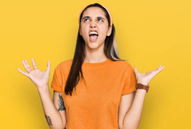 Genç İspanyol kadın gündelik kıyafetler giyip deli gibi bağırıyor ve agresif bir ifade ve kollarla bağırıyor. hüsran kavramı. 