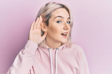 Sıradan kıyafetler giyen, el pençe divan gülümseyen, dedikodu ya da dedikoduları dinleyen genç sarışın kız. Sağırlık kavramı. 