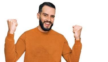 Sakallı, sıradan bir kazak giyen genç adam gururla bağırıyor, zaferi ve başarıyı kutluyor. 