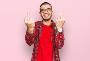 Hispanic young man wearing casual clothes showing middle finger doing fuck you bad expression, provocation and rude attitude. screaming excited 