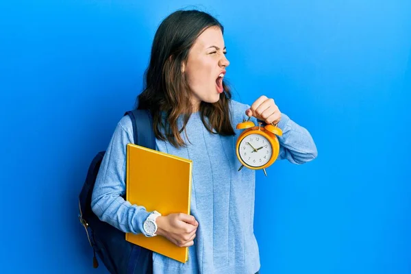 Young Brunette Student Woman Holding Alarm Clock Angry Mad Screaming — Stock Photo, Image